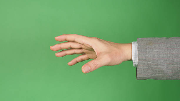 istock an outstretched hand wearing suit on green screen background. 2231968747
