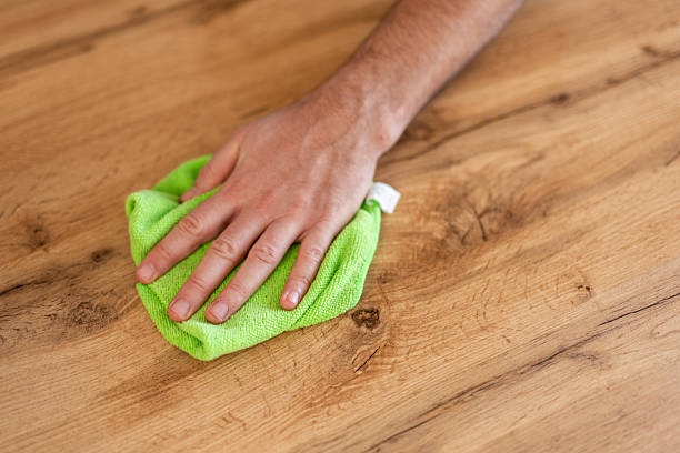 istock A man is cleaning a table at home, wiping down the surface to maintain a clean and organized space. The image captures a moment of home upkeep and attention to cleanliness in a cozy, everyday setting. 2231969712