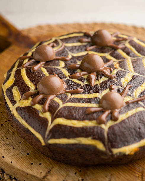Chocolate cake decorated with a spiderweb and chocolate spiders. Special recipe for Halloween..