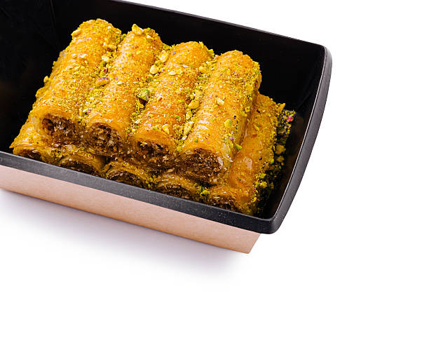 istock Delicious baklava rolls made with nuts and honey in elegant box 2231975242