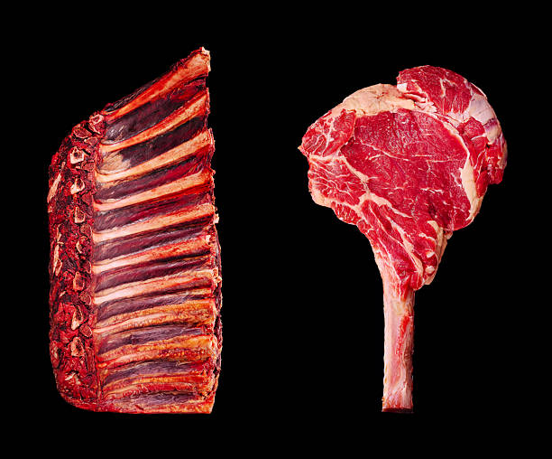 istock Freshly cut prime rib showcased with a T-bone steak on a dark background 2231975314