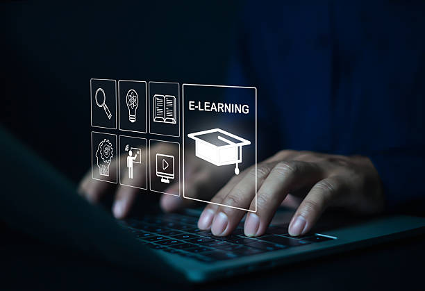 istock Businessman typing on laptop with e-learning icons including book, video, and online class, representing digital education, remote study, virtual training, knowledge sharing, and modern learning technology. 2231980074