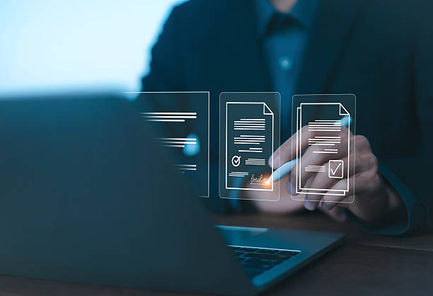 istock Businessman using digital pen to sign electronic documents on laptop, symbolizing online contract, e-signature, paperless workflow, modern business agreement, and secure digital approval. 2231980538