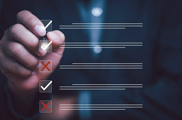 istock Businessman hand checking boxes on digital checklist with tick and cross marks, representing task management, evaluation, decision making, project planning, and business productivity in modern corporate concept. 2231980806