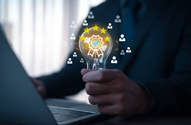 istock Businessman holding light bulb with five-star rating and quality certification icon, symbolizing customer satisfaction, innovation, leadership, and corporate success in business strategy. 2231980937