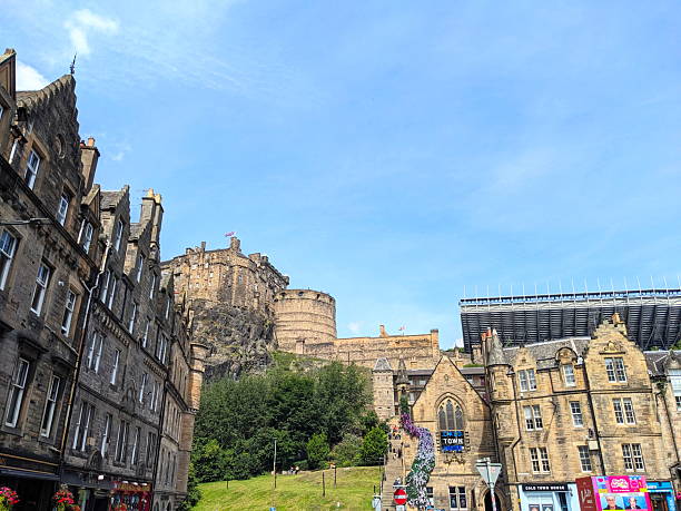 Edinburgh, Scotland - July 17 2025: Historic Edinburgh Castle stands on its rock overlooking the traditional stone buildings and steep streets of the city's famous Old Town under a clear summer sky