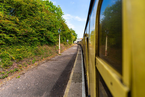 istock Vintage train leaving a small station on a sunny day 2231981573