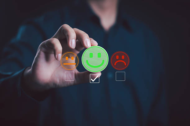 istock Hand selecting green happy face in customer feedback survey, symbolizing positive review, user satisfaction, service quality evaluation, business improvement, customer experience, and rating system. 2231981619