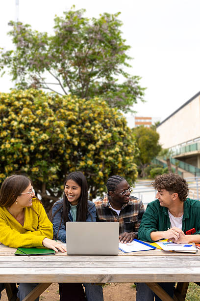 istock University students collaborating on a project outdoors 2231983309