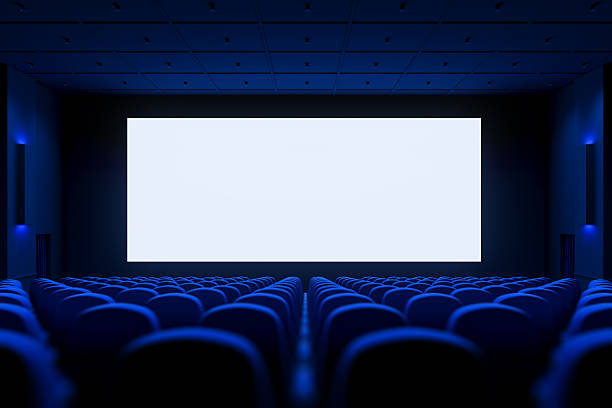istock Empty modern cinema interior with blank white screen and blue seats arranged in rows under ceiling lights for presentation or mockup template use. 3D Rendering 2231983534