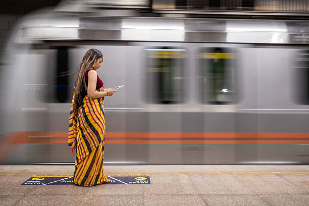 istock Indian girl using a digital tablet at metro station, India 2231984742
