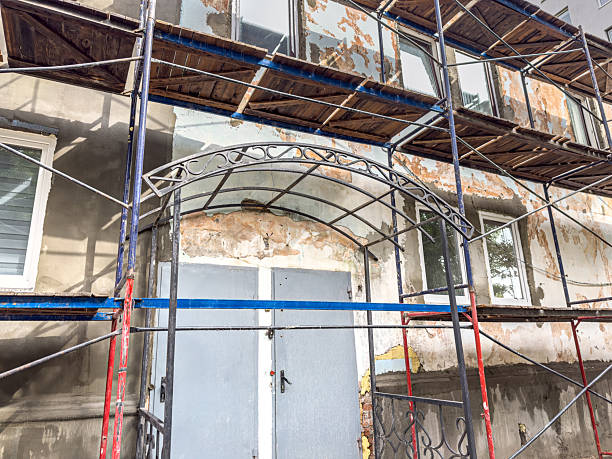 old building under renovation works. construction scaffolding on building facade.