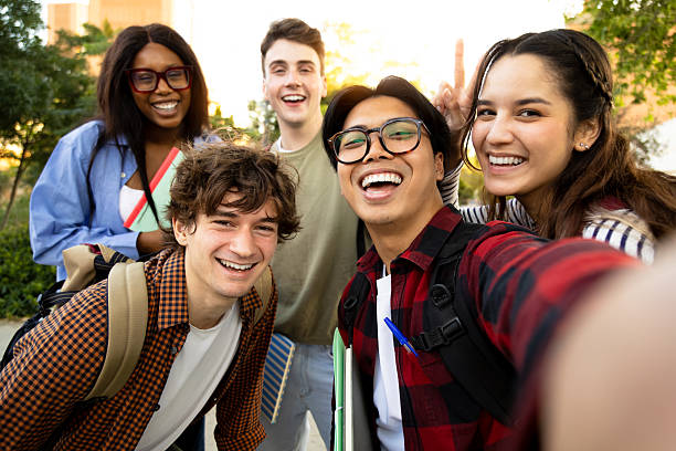 istock Cheerful university students taking a selfie outside campus 2231986115