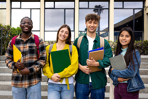 istock Smiling university students holding books and looking at camera 2231986129