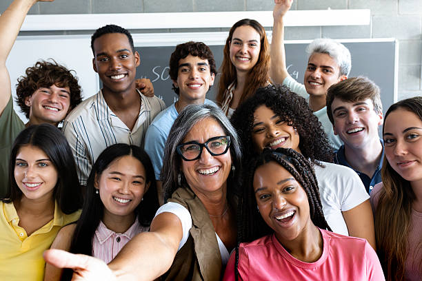 istock Happy teacher and students taking a selfie in classroom 2231986150