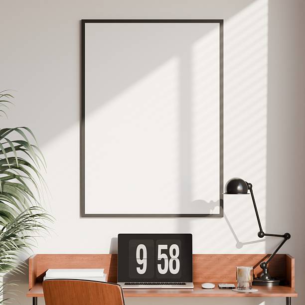 istock Modern Home Office Interior with Wooden Desk, Chair, and Vertical Blank Frame Mockup on Wall 2231990973