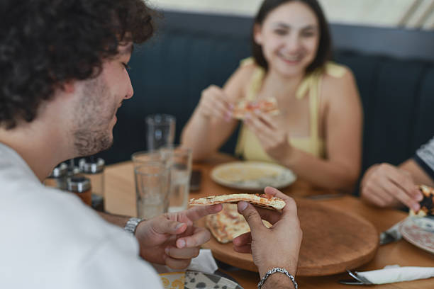 istock Male  Holding Fresh Pizza Slice Close To Face While Preparing To Eat 2231992886