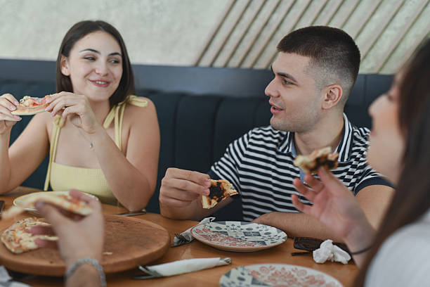 istock Joyful Friend Group Holding Pizza Slices While Talking And Smiling 2231993912