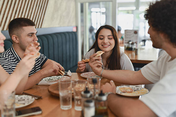 istock Couples On Double Date Enjoying Pizza And Funny Conversations 2231993955