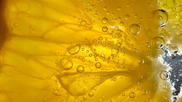 Close-Up of Yellow Liquid Containing Air Bubbles and Details