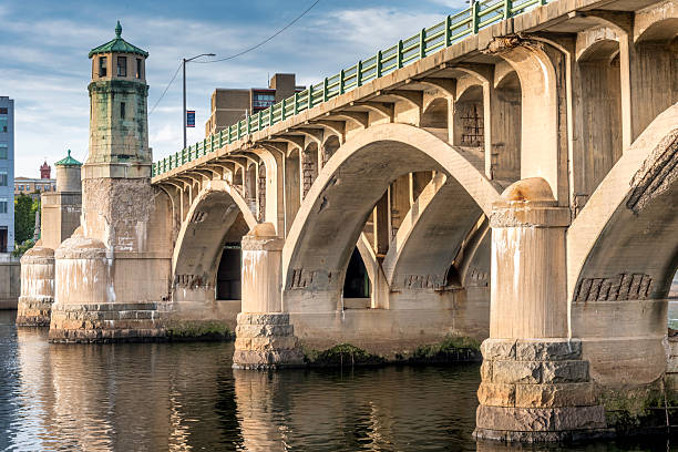 Haverhill MA USA Aug 24 2025: The PFC Ralph T. Basiliere Bridge iin Haverhill is viewed here in late afternoon, low sun, casting a golden glow on the bridge. This historic bascule-style span built in 1925 that carries Route 125 (Bridge Street) across the Merrimack River, connecting downtown Haverhill with Bradford. \n\nBecause of its age and state of deterioration, Massachusetts Department of Transportation has launched a full replacement project. Construction is anticipated to begin in late 2025.