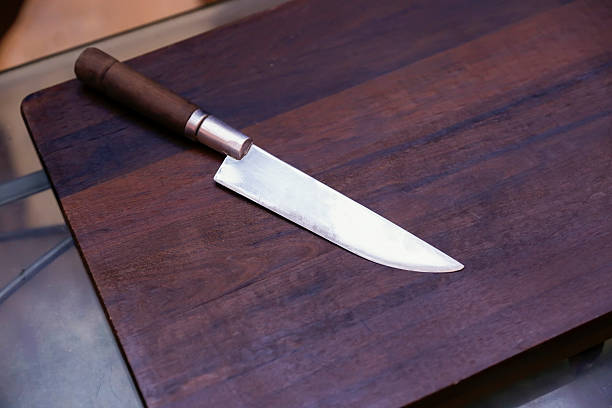 istock Sharp knife on natural wooden countertop 2231997329