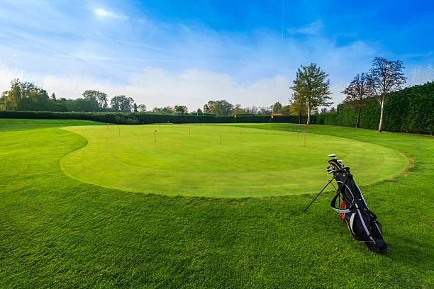 istock Golf clubs bag standing on a putting green inside a golf course 2231998927