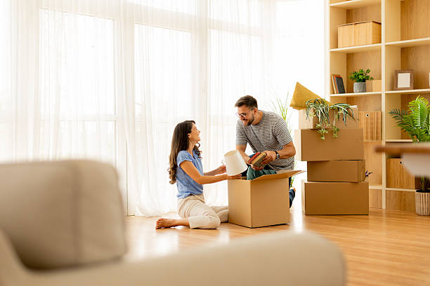 istock Couple joyfully unboxing their new home decor during a sunny afternoon 2231999112