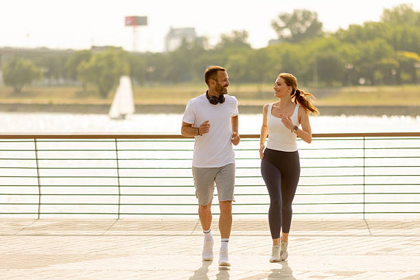 istock Joyful morning jog by the riverside with friendly conversation and smiles 2231999716