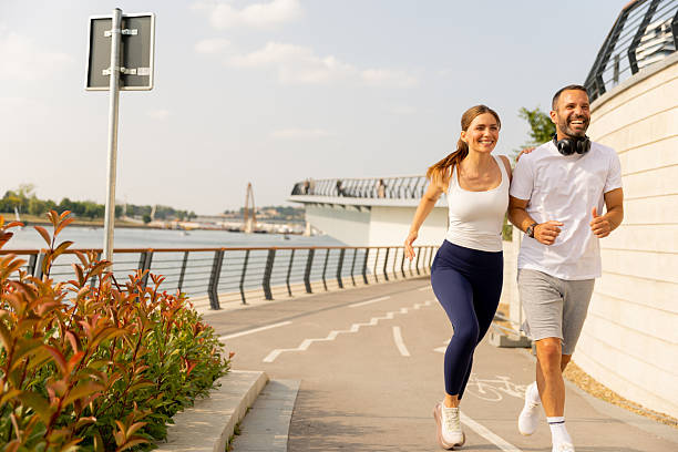 istock Couple enjoys a joyful run along the scenic waterfront path on a sunny afternoon 2231999728