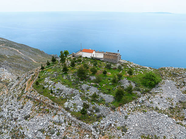 Theth -Albania, One of the most wild and untouched natural alps mountain, Typical scene of Theth mountain - healthy horses with the historic church