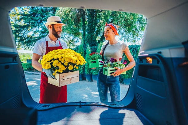 istock Gardener helping customer load fresh flowers into a car trunk 2232006493