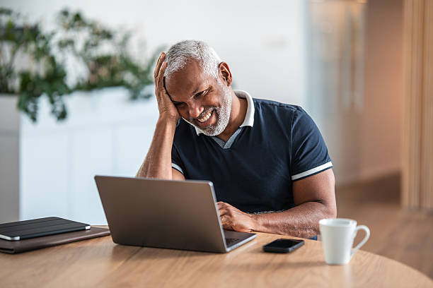 istock Relieved Mature Hispanic Businessman Using Laptop in Office 2232008671