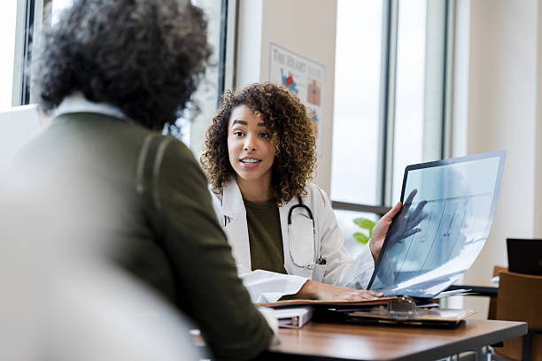 istock Doctor explaining X-ray to patient during consultation 2232012290