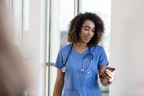 istock Confident Female Doctor Using Smart Phone in Hospital 2232012327