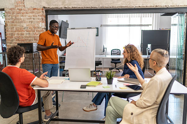 istock Young businessman explaining strategy to colleagues during a meeting 2232013508