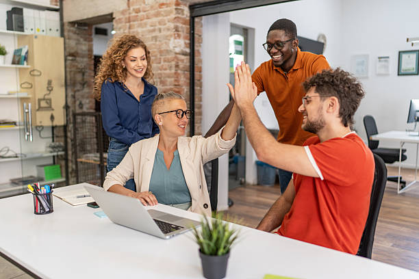 istock Business team celebrating success with high five in office 2232013869