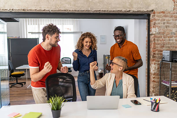 istock Excited business team celebrating success in modern office 2232013946