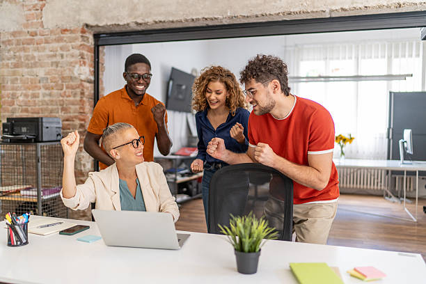 istock Excited business team celebrating success in modern office 2232013969