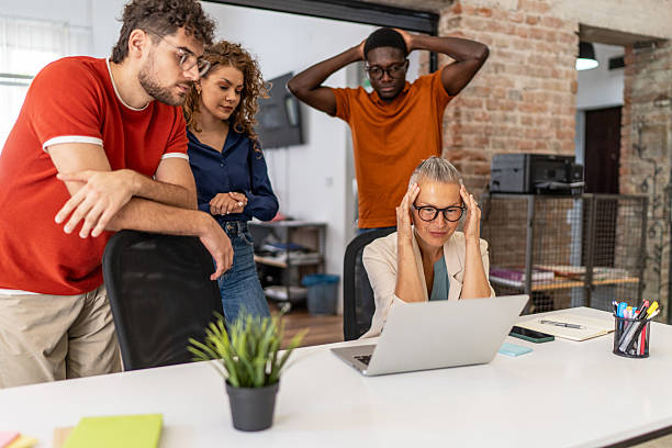 istock Stressed business team looking at laptop in office 2232014051