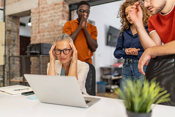 istock Stressed businesswoman having headache while working on laptop 2232014089