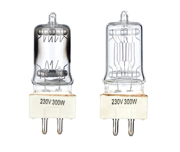 Two halogen light bulbs 230V 300W isolated on white background, one burnt out with dark glass, the other working clear bulb. High resolution image patch included inside file.
