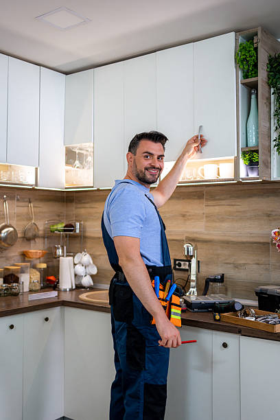 istock Skilled handyman organizes kitchen cabinets in modern home during daylight hours 2232015606