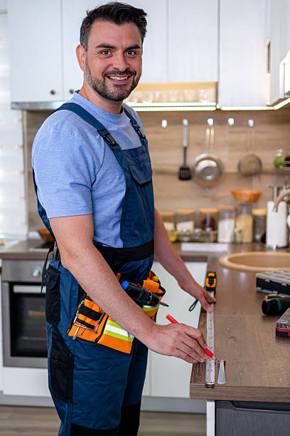 istock Skilled worker measuring countertop in modern kitchen during home improvement project 2232015663