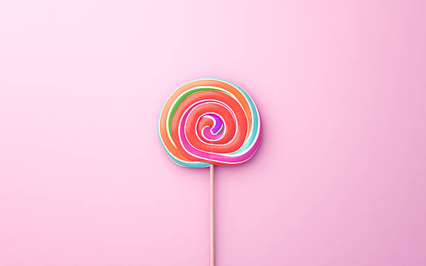istock Multicolored Flavored Spiral Candy Lollipop on Pink Soft Background 2232017498
