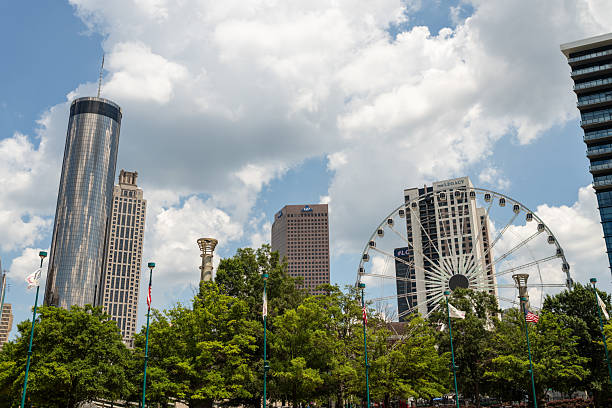 Atlanta, GA, USA - June 22, 2025: The Atlanta skyline as viewed from Centennial Olympic Park on a beautiful day with clouds in the sky.
