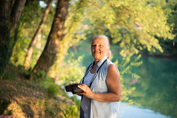 istock Mature woman with binoculars 2232021369