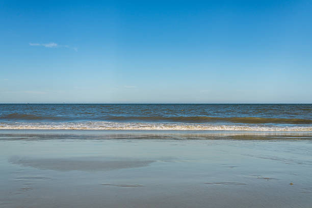 Beach seaside under blue sky and white clouds