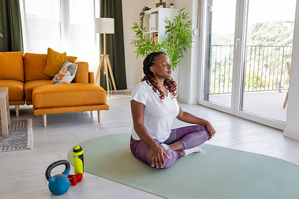 istock Focused young woman doing yoga practice in cozy interior 2232025562