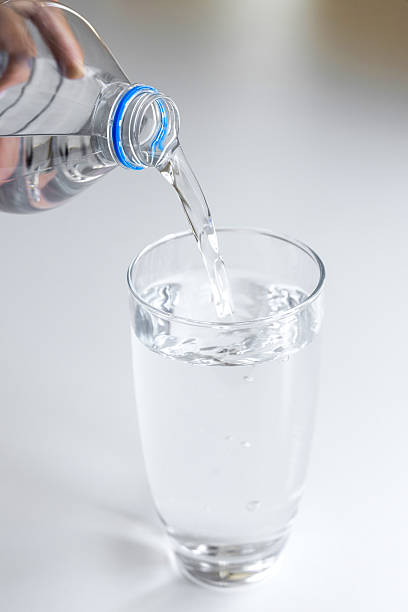 istock Unrecognizable female pouring water 2232028583